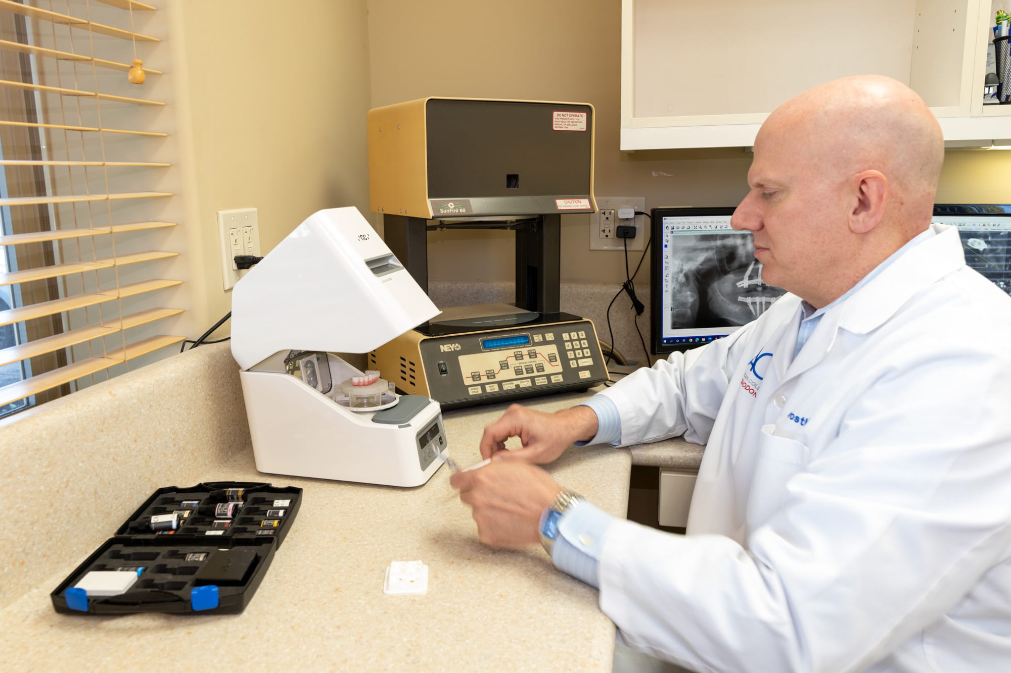 Dr. Andrus in the in-house lab fabricating ceramic restorations next to the SunFire 60 firing oven