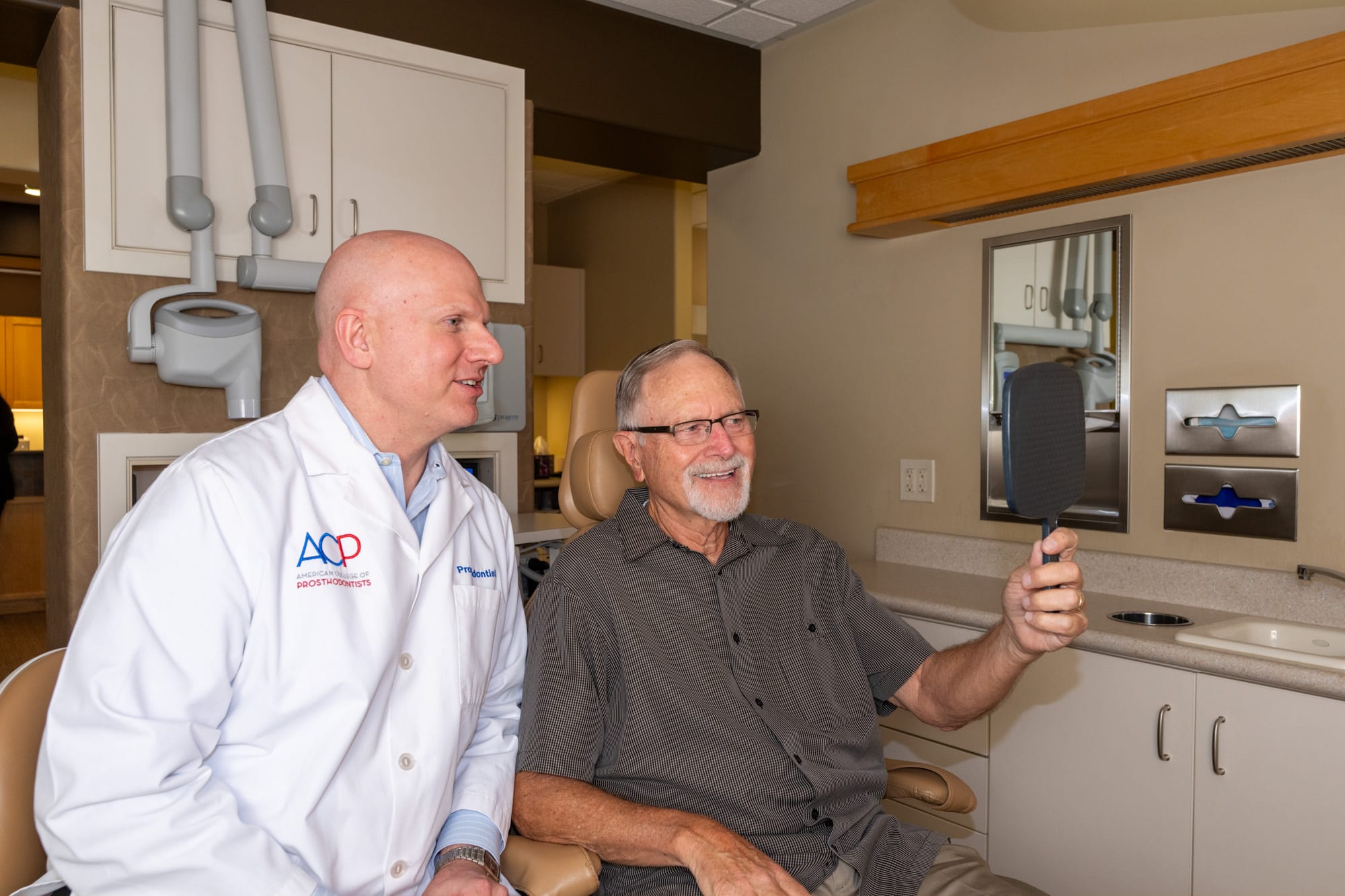 Dr. Andrus reviewing a patient's full-arch bite analysis chairside