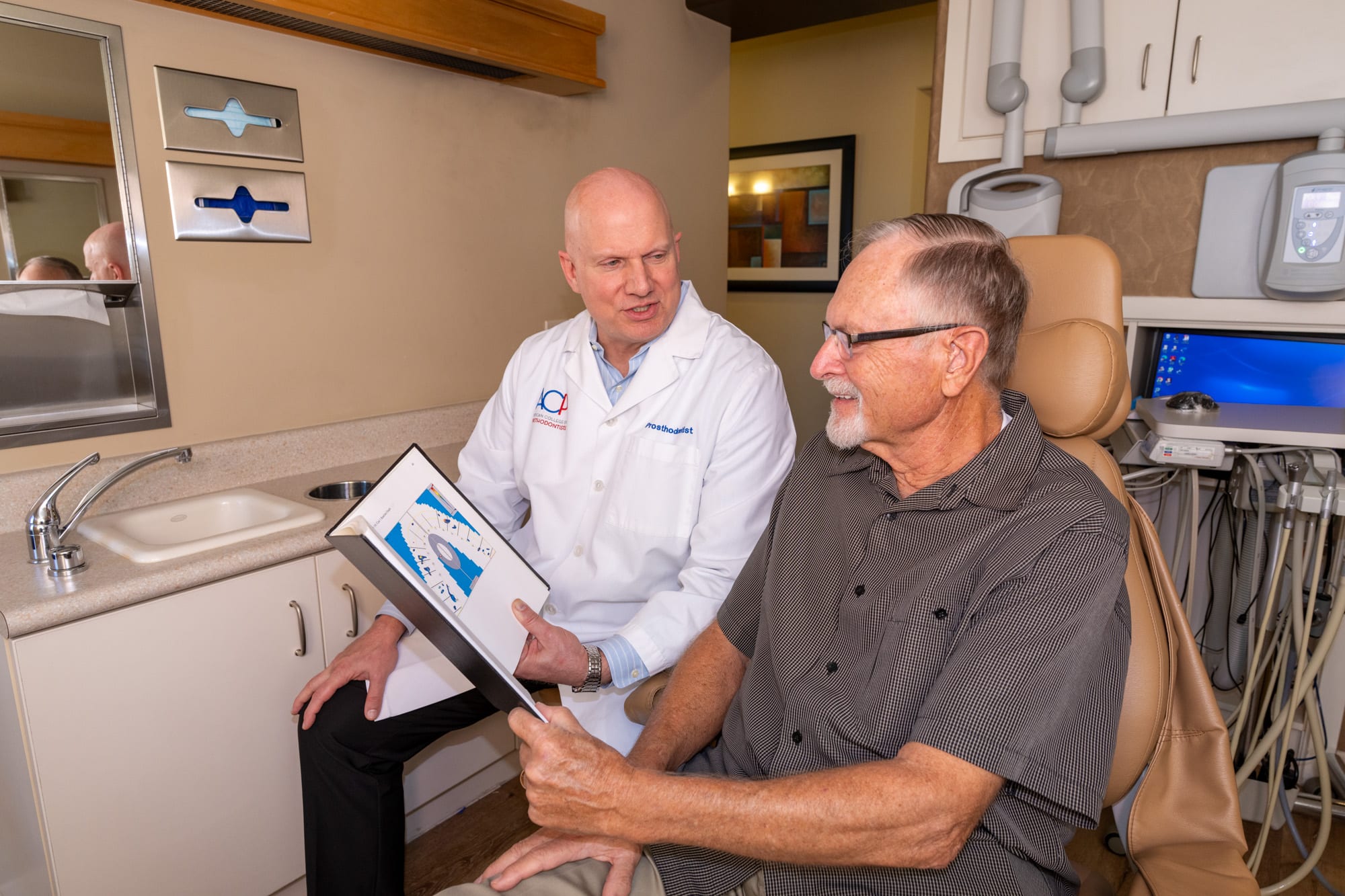 Dr. Andrus listening to a patient chairside