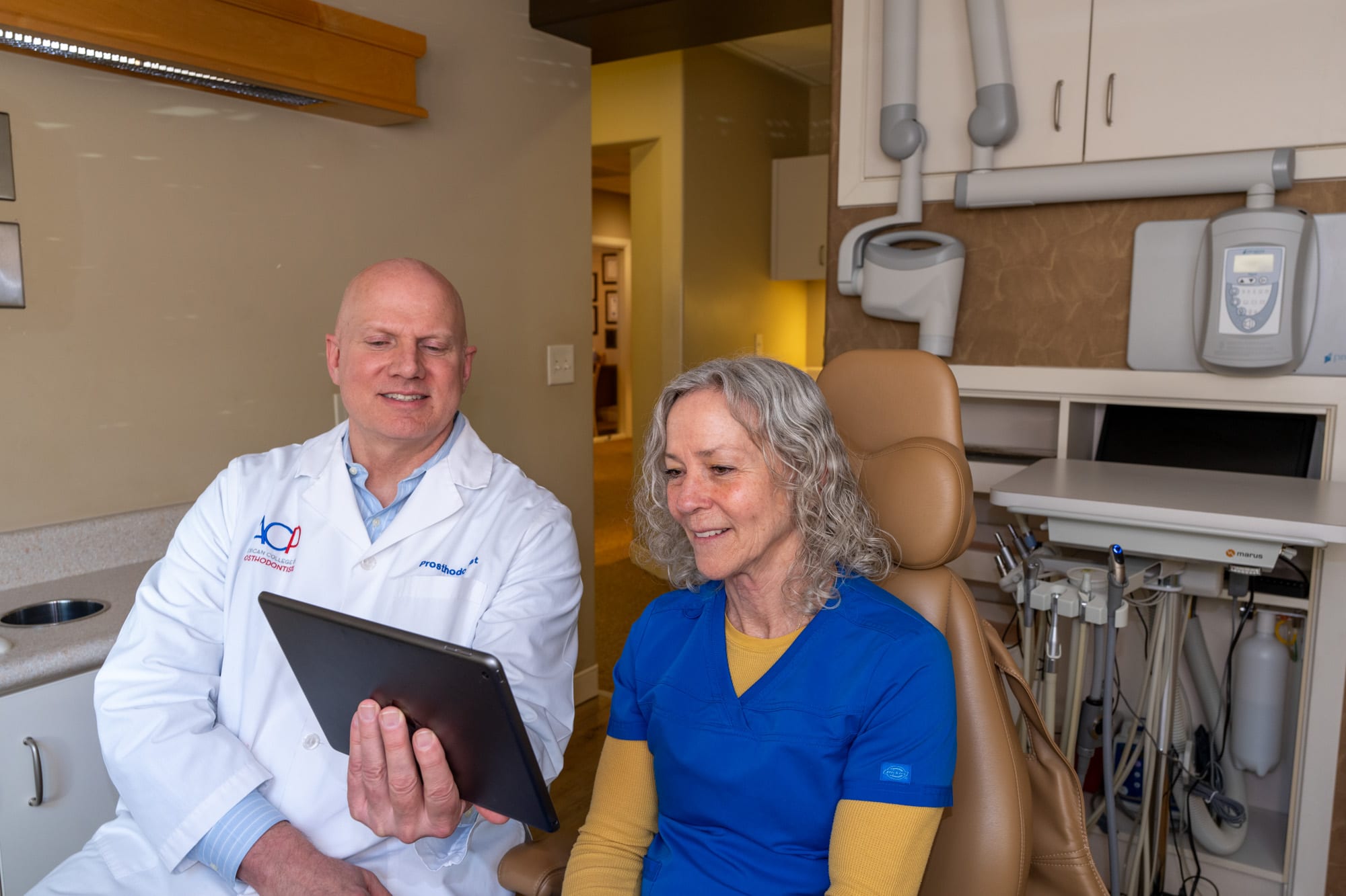 Dr. Andrus reviewing the treatment plan with a patient on an iPad